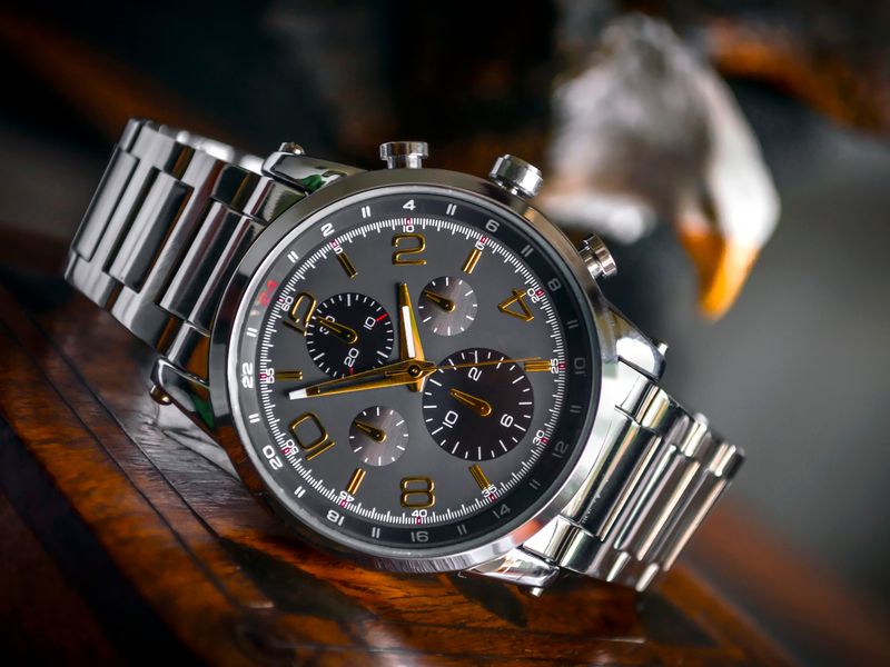 Steel luxury sports chronograph on a dark surface